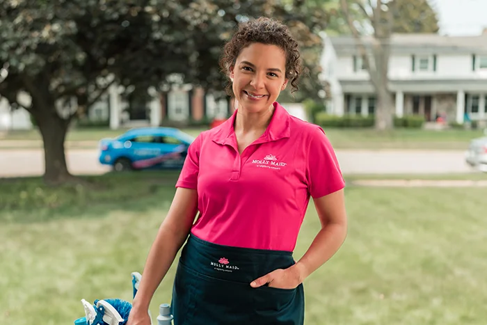 Molly Maid professionals greeting customer before a recurring cleaning service appointment.