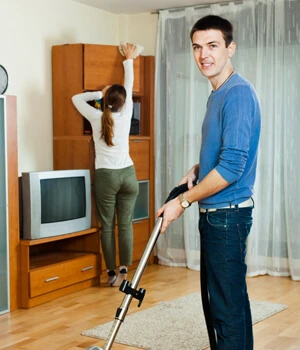 Woman dusting furniture.