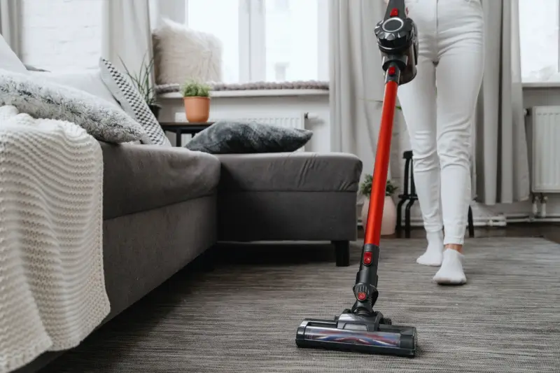 Woman vacuuming her living room.