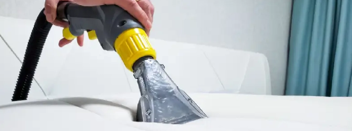 Mattress being cleaned with a vacuum.