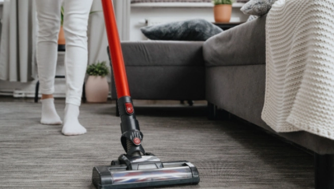 Woman vacuuming living room