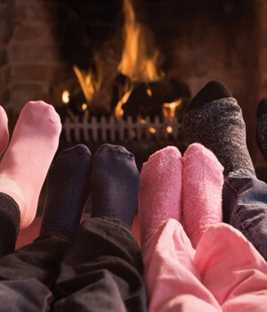 Family warming feet on the fireplace.