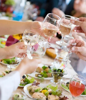 people toasting with wine glasses.