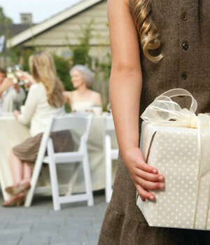 woman hiding a gift behind her back.