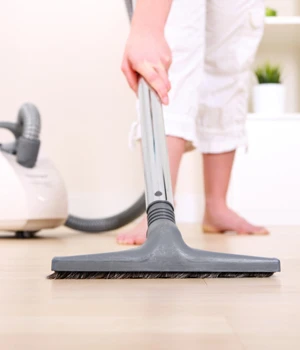 woman vacuuming the floor.