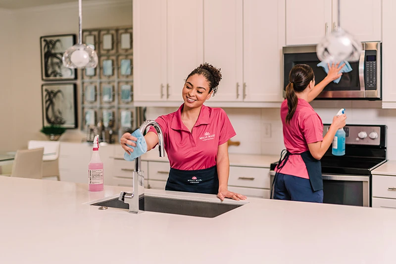 Molly Maid service professionals cleaning a home kitchen