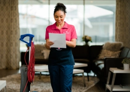 Molly Maid employee looking at a home cleaning plan.