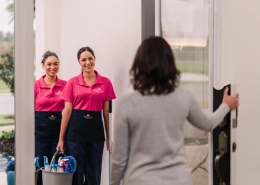 Molly Maid customer greeting maids at her front door.