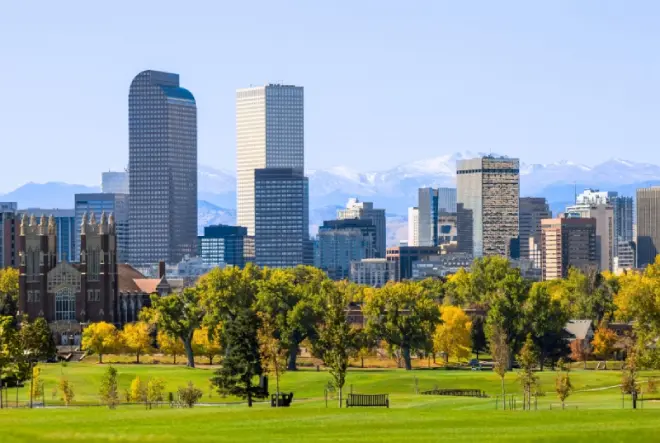 Denver skyline with Rocky Mountains in the background.