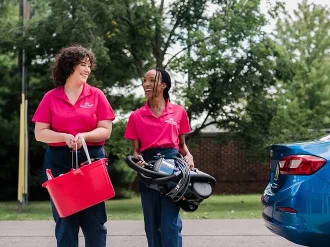 Molly Maid service professionals walking into a cleaning appointment.