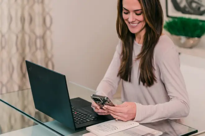 Woman sitting at a desk contacting her local Molly Maid for an appointment.