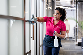 Molly Maid cleaning the windows of a commercial business.