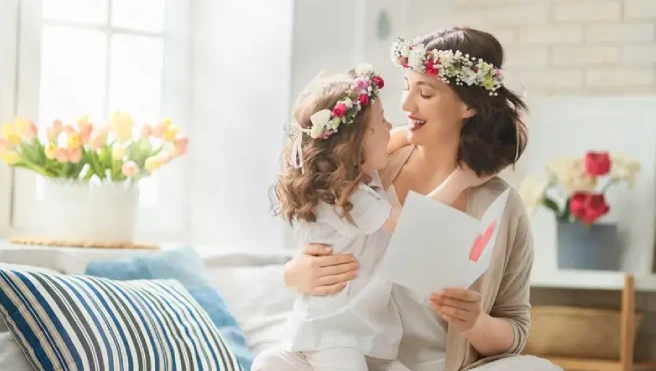 A mother and daughter in flower crowns celebrating Mother's Day.