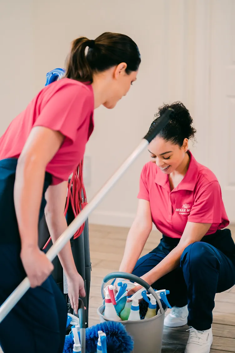 Molly Maid professionals packing up their house cleaning supplies.