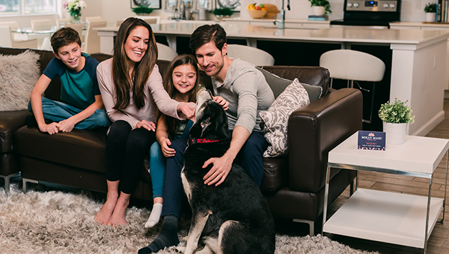 A family happy with a clean room after a Molly Maid service.