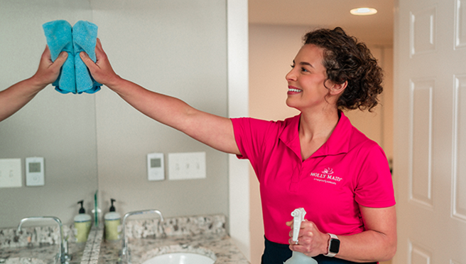 Molly Maid employee cleaning a customer’s new home.