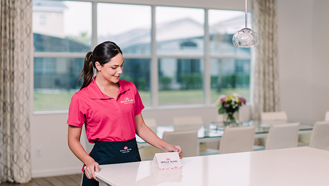 Maid placing tent card on a counter after service.