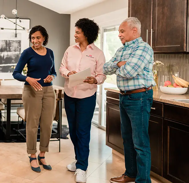 Molly Maid employee showing a couple their cleaning plan.