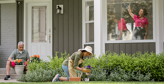 A Molly Maid professional providing a spring cleaning for a homeowner.