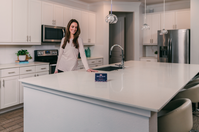 Molly Maid customer in her kitchen after post-construction cleaning.