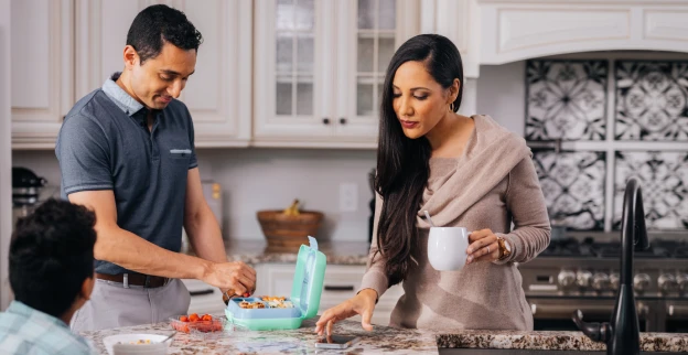 Family making snacks together in the kitchen.