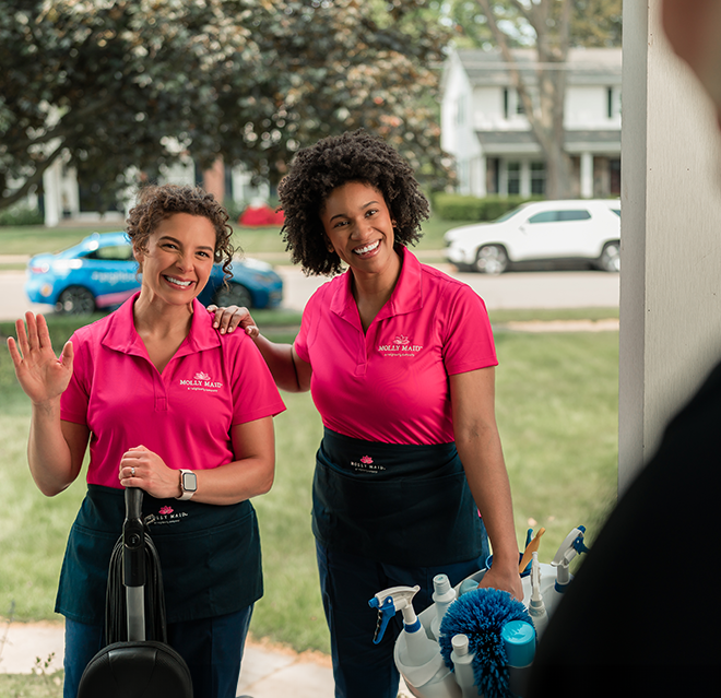 Two Molly Maids arriving at a customer's home.