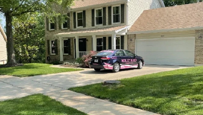 Molly Maid of St. Louis company car parked in a driveway during a home cleaning appointment.