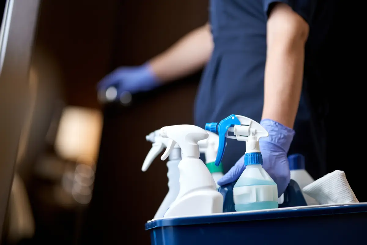 house cleaner carrying cleaning supplies.