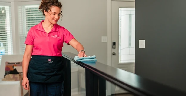 A Molly Maid professional providing home cleaning service.