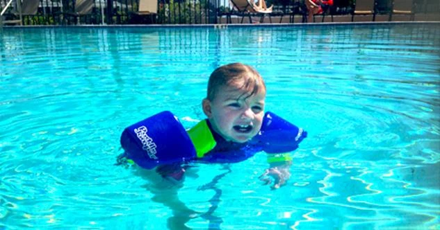 child swimming in a pool