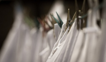 White clothing pinned by clothespins to a clothesline. Photo Credit: Lennart Tange on Flickr.