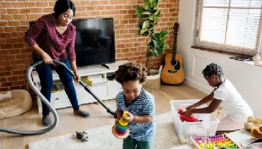 Mother at home doing chores with her children