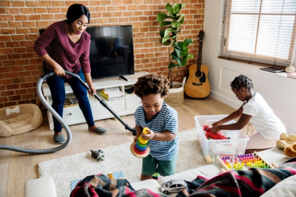 Mother at home doing chores with her children