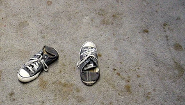 A pair of shoes on dirty, stained carpet. Photo: Dong Jun on Flickr.