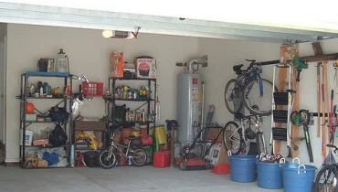 A neatly organized garage with bikes, storage units, and storage bins lining the perimeter