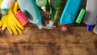 Variety of house cleaning products on a wood table