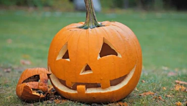 Two pumpkins with carved Halloween faces