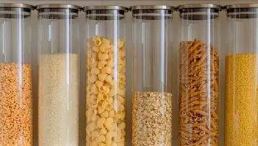 Food in clear jars organized neatly in a pantry