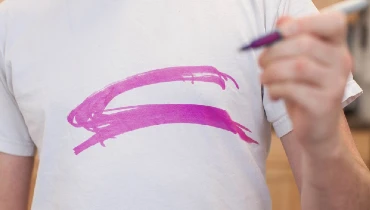 Pink permanent marker on a white shirt.