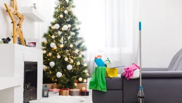 Cleaning supplies in living room with Christmas decorations