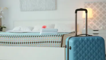 Blue suitcase in guest bedroom at home