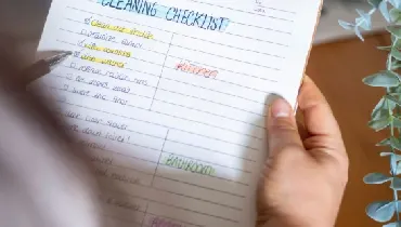 Woman holding a housecleaning checklist