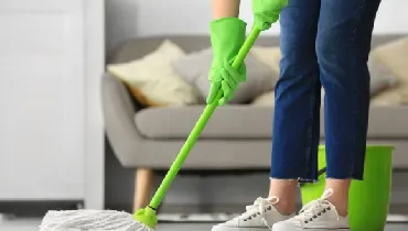 Woman mopping the floor in her living room