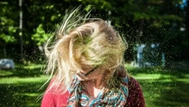 Woman shaking her hair free of glitter