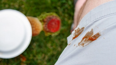 Close-up of ketchup stain on white shorts.