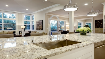 Clean modern kitchen with sparkling granite countertops.