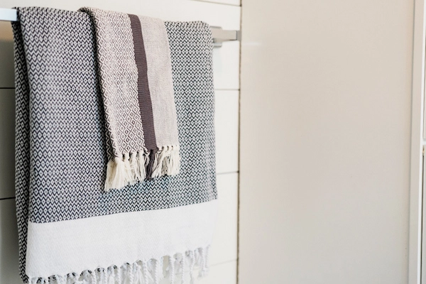 Turkish towels hanging on bathroom towel rack.