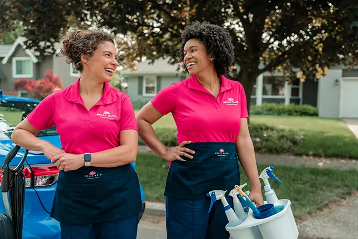 Molly Maid professionals outside before a cleaning appointment.